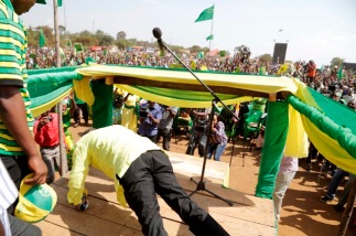 CCM candidate, John Magufuli, demonstrates his physical fitness at a rally by doing several push-ups. 